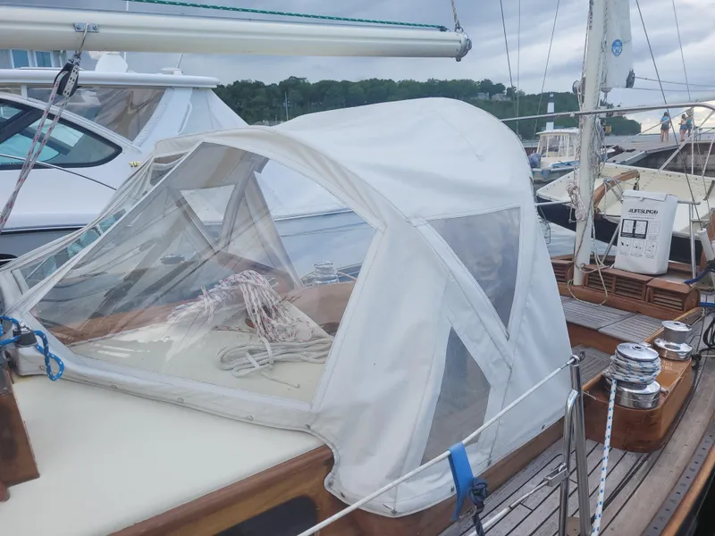 Slide: The Image of 1969 Allied Seabreeze 35 sailboat with white canopy docked at marina. - 5