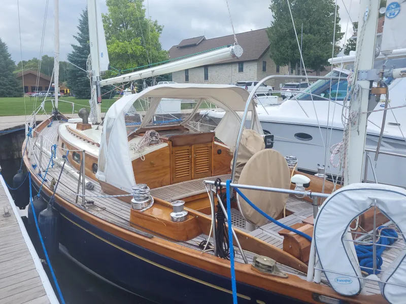 Slide: The Image of 1969 Allied Seabreeze 35 sailboat docked, featuring wooden deck and classic design. - 6