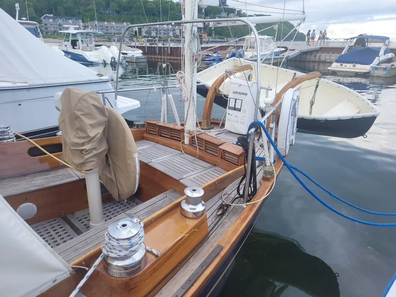 Slide: The Image of 1969 Allied Seabreeze 35 sailboat docked in a marina, showcasing wooden deck and rigging. - 7
