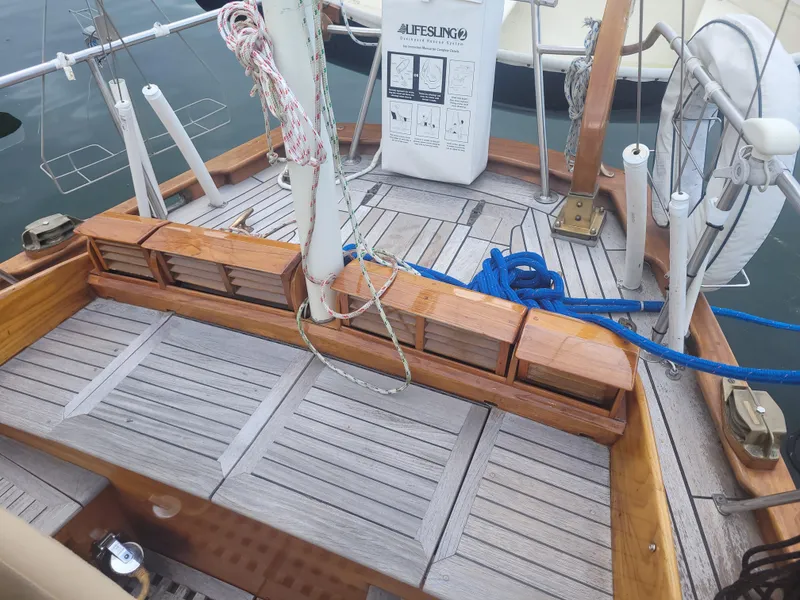 Slide: The Image of Wooden deck of 1969 Allied Seabreeze 35 sailboat with ropes and lifesaving equipment. - 9
