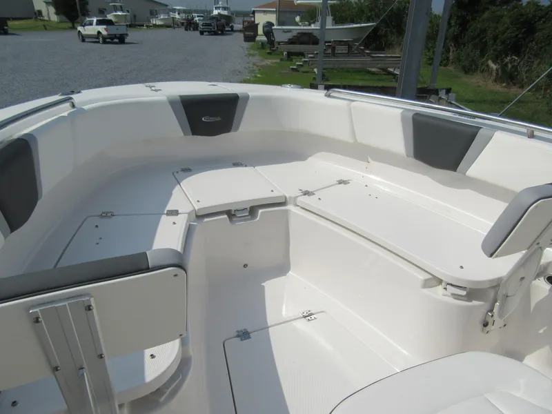 Slide: The Image of 2023 Robalo R250 CC boat interior with seating and storage compartments. - 10