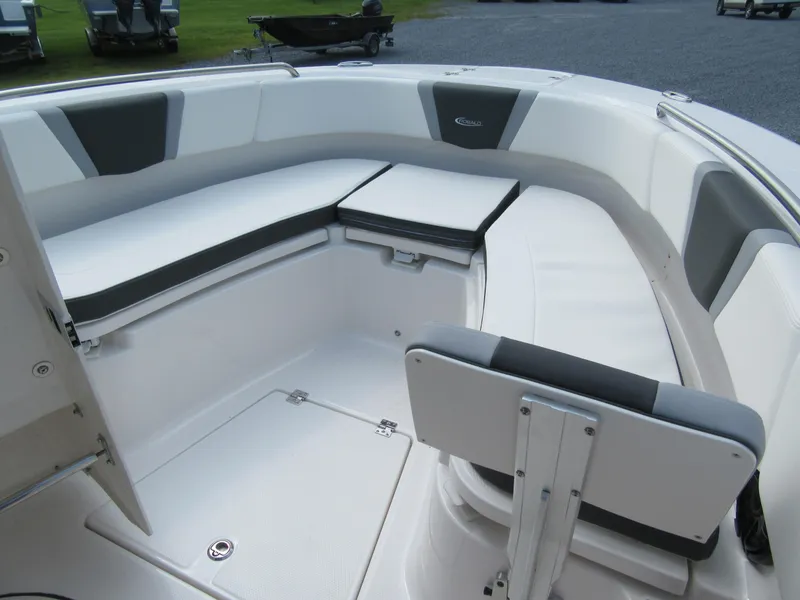 Slide: The Image of 2023 Robalo R250 CC boat interior with cushioned seating and storage compartments. - 15