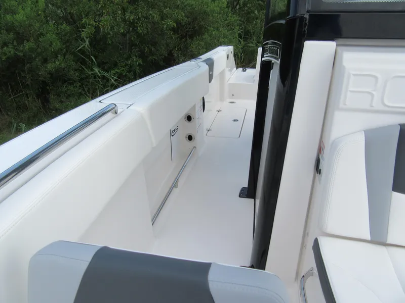 Slide: The Image of 2023 Robalo R250 CC boat interior with white and gray seating. - 16