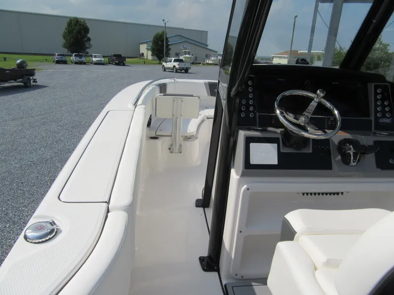Slide: The Image of 2023 Robalo R250 CC boat interior with steering wheel and seating. - 9
