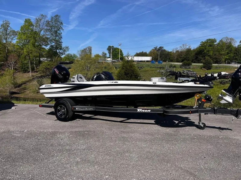 Slide: The Image of 2023 Triton 179 TrX fishing boat on trailer in outdoor setting. - 10