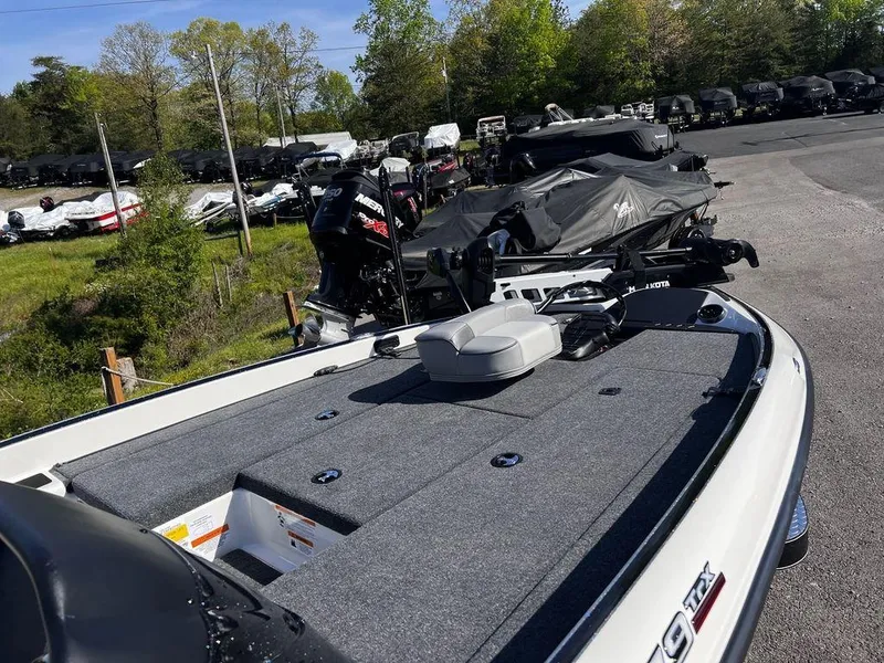 Slide: The Image of 2023 Triton 179 TrX bass boat on display in a dealership lot. - 8