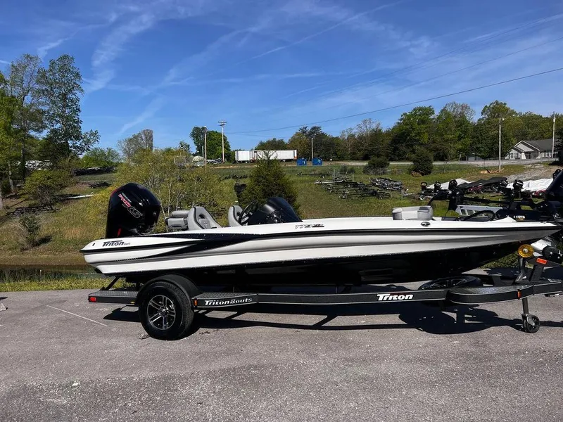 Slide: The Image of 2023 Triton 179 TrX boat on trailer in outdoor setting. - 9