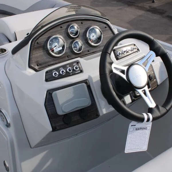 Slide: The Image of 2023 Lowe SS210 Super Sport boat dashboard with steering wheel and gauges. - 7