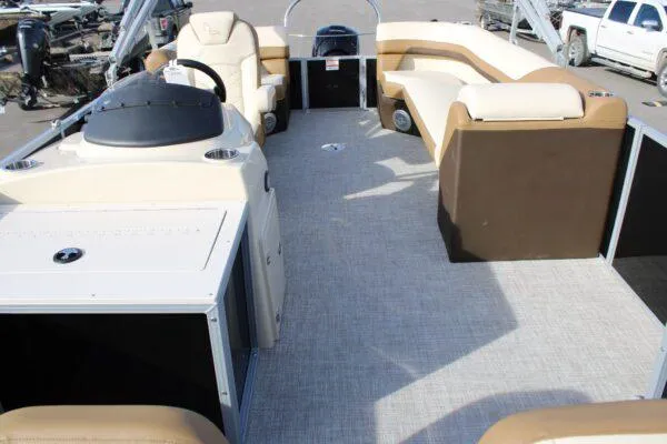 Slide: The Image of 2023 Lowe SF212 pontoon boat interior with beige and brown seating. - 3