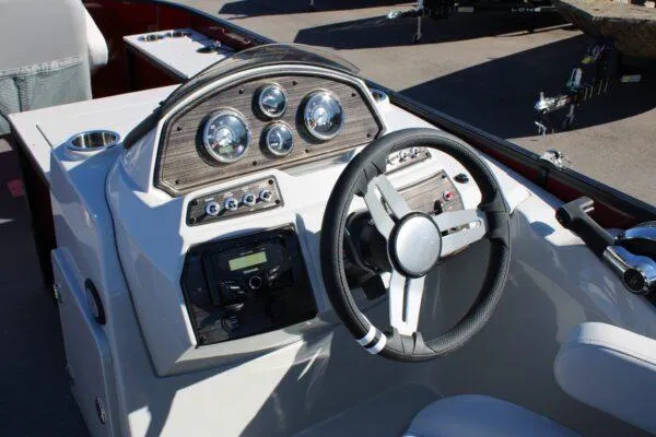 Slide: The Image of 2023 Lowe SF214 Sport Fish boat dashboard with steering wheel and control panel. - 6
