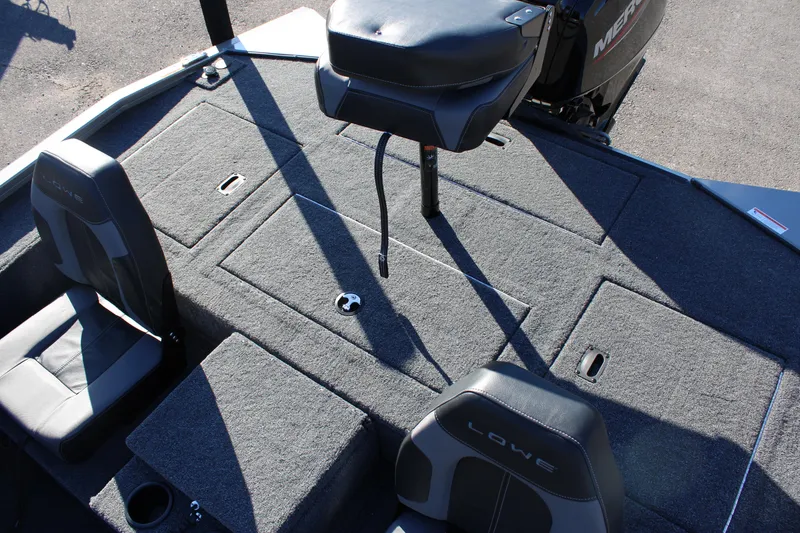 Slide: The Image of 2023 Lowe ST178 boat interior with cushioned seats and storage compartments. - 12