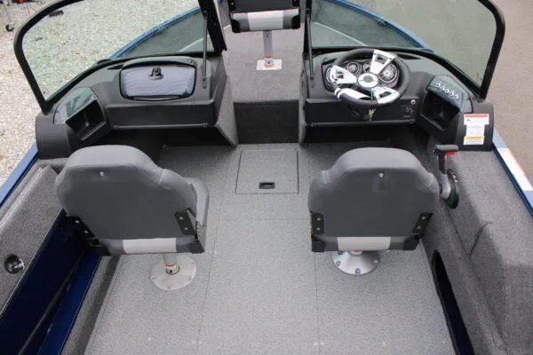 Slide: The Image of 2023 Lowe FM1675 boat interior with dual seats and control console. - 3