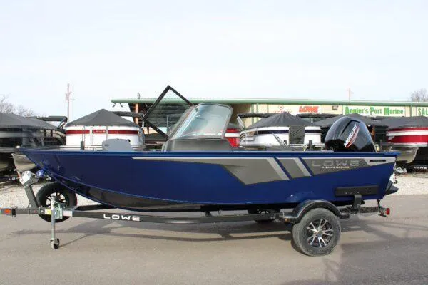Slide: The Image of 2023 Lowe FM1675 boat in blue on a trailer, side view. - 5