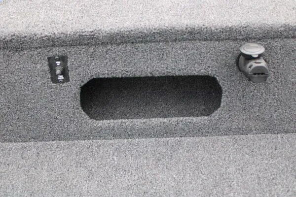 Slide: The Image of 2023 Lowe FM1675 boat interior with storage compartment and control switches. - 8