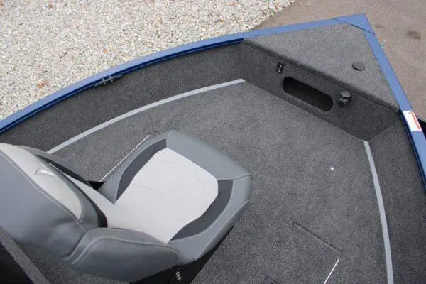 Slide: The Image of 2023 Lowe FM1675 boat interior with gray seating and carpeted deck. - 9