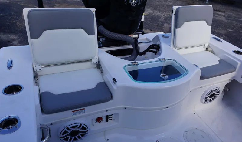 Slide: The Image of 2023 Everglades 243 CC boat interior with seating and storage compartments. - 15