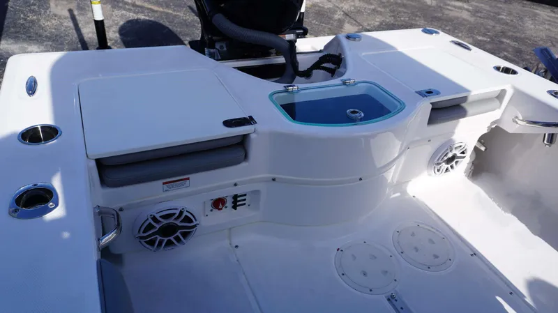 Slide: The Image of 2023 Everglades 243 CC boat interior with seating, storage, and speakers. - 16