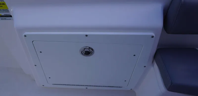 Slide: The Image of 2023 Everglades 243 CC boat storage compartment with secure latch. - 25