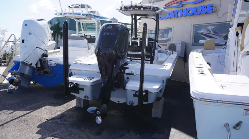 Slide: The Image of 2023 Everglades 243 CC boat with powerful outboard motor at a dealership. - 3