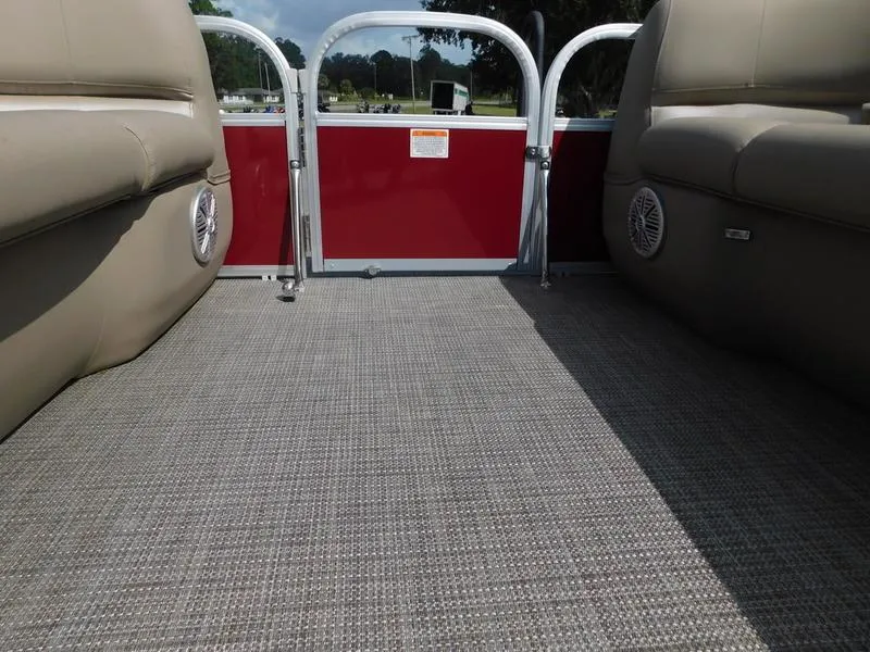 Slide: The Image of 2023 Ranger Reata 200C boat interior with beige seating and gray flooring. - 10