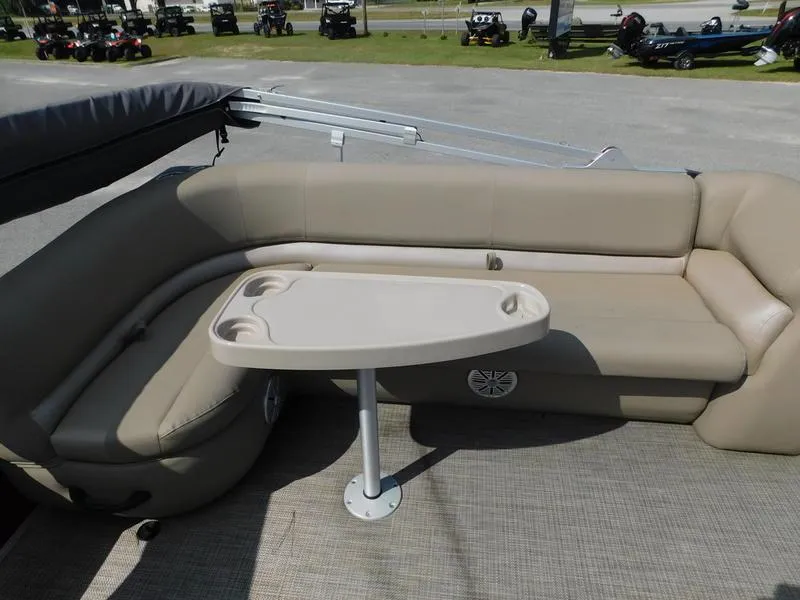 Slide: The Image of 2023 Ranger Reata 200C boat interior with beige seating and table. - 5
