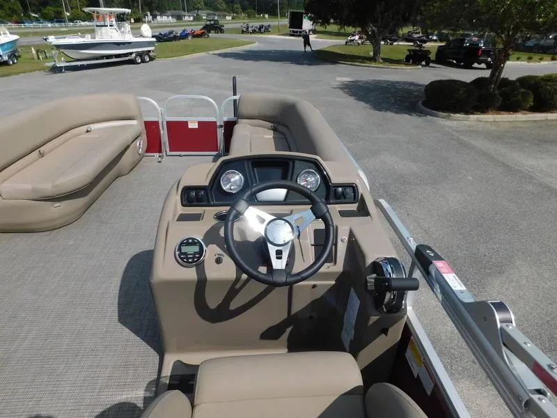 Slide: The Image of 2023 Ranger Reata 200C boat interior with steering wheel and seating. - 7