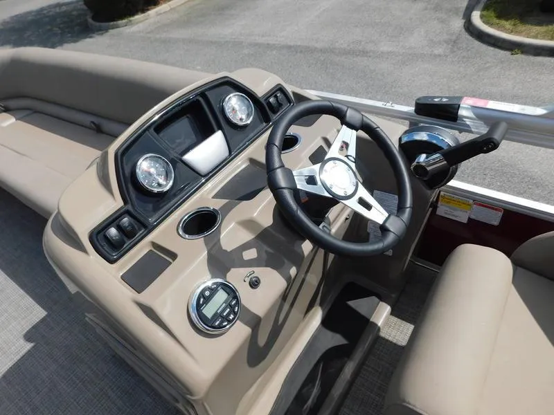 Slide: The Image of 2023 Ranger Reata 200C boat dashboard with steering wheel and controls. - 8