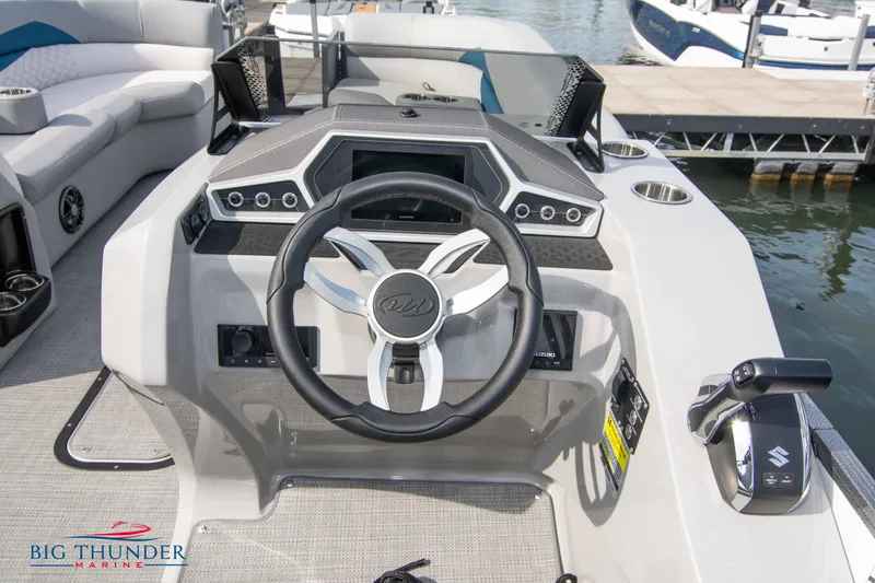 Slide: The Image of 2022 Manitou 25 Encore RF SHP boat dashboard with steering wheel and controls. - 4