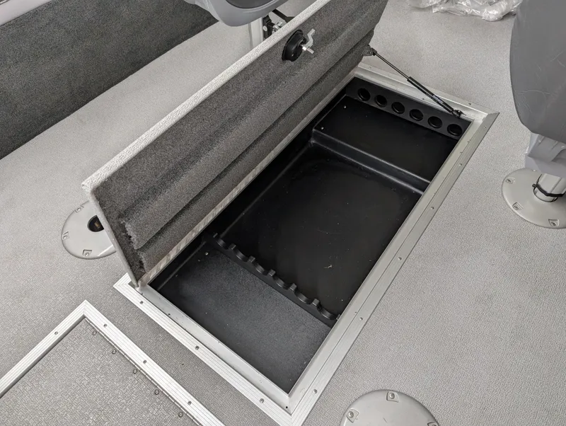 Slide: The Image of 2023 Starcraft Superfisherman 186 boat with open storage compartment. - 10