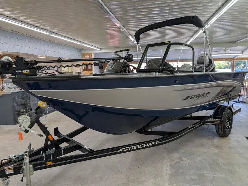 Slide: The Image of 2023 Starcraft Superfisherman 186 boat in showroom, featuring sleek design and modern features. - 11