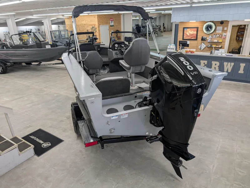 Slide: The Image of 2023 Starcraft Superfisherman 186 boat with Mercury V6 engine in showroom. - 2