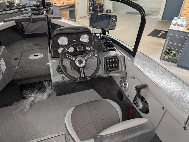 Slide: The Image of 2023 Starcraft Superfisherman 186 boat interior with steering wheel and dashboard controls. - 3