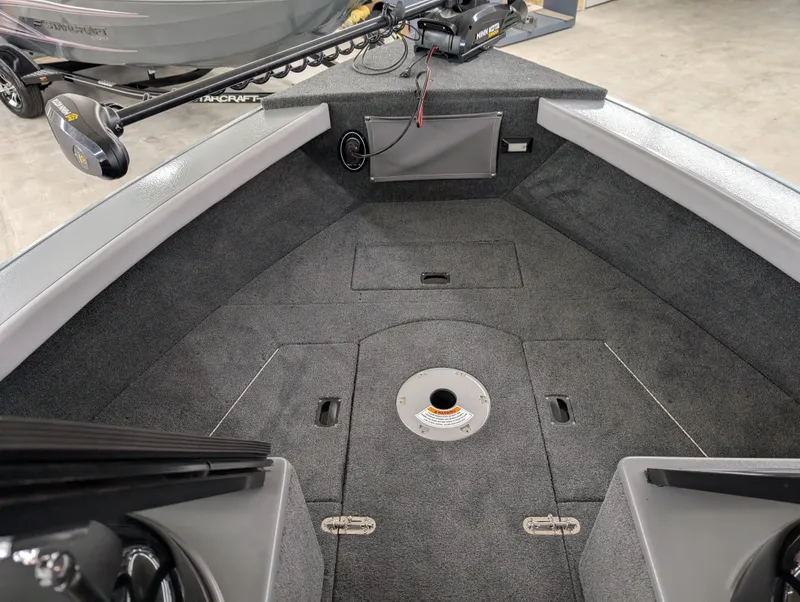 Slide: The Image of 2023 Starcraft Superfisherman 186 boat interior with carpeted deck and storage compartments. - 6