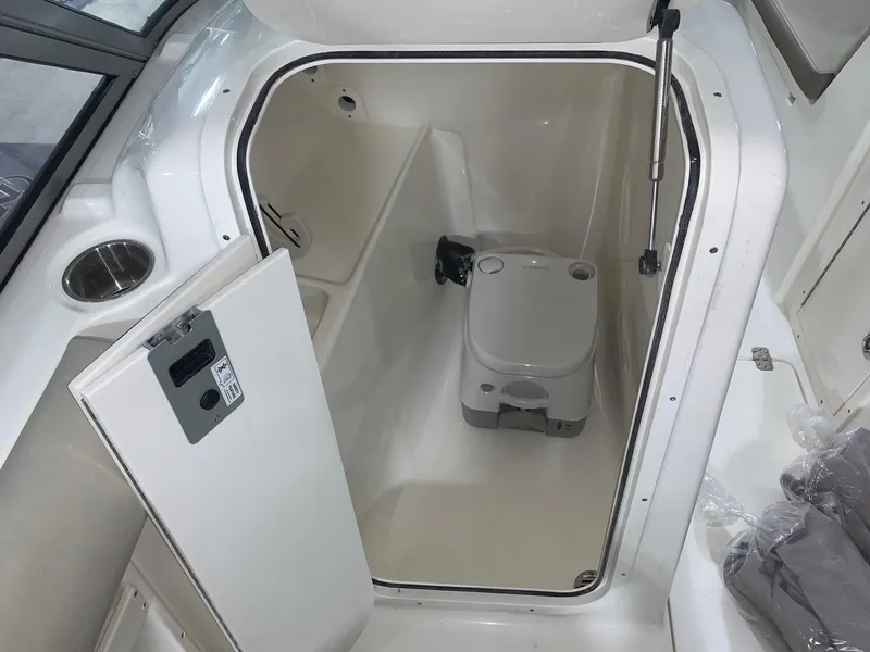 Slide: The Image of 2024 Key West 239 DFS boat interior with compact marine toilet. - 13