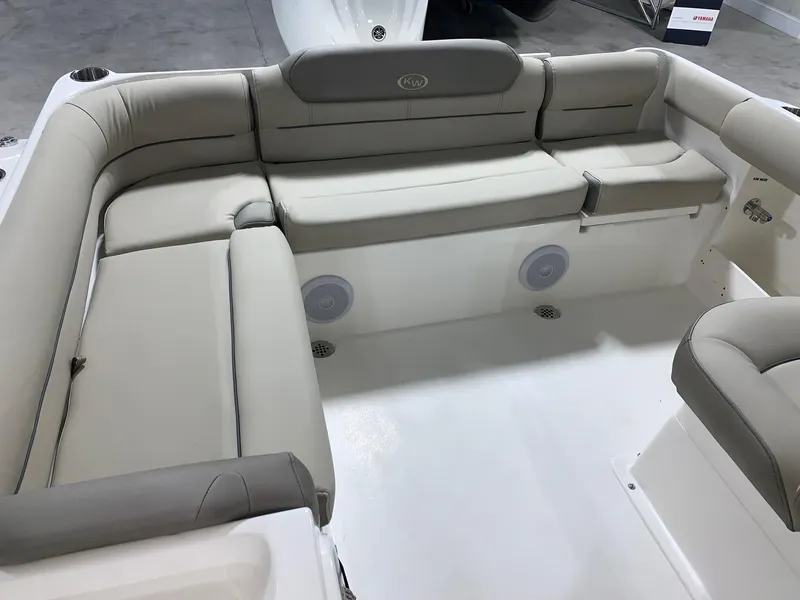 Slide: The Image of 2024 Key West 239 DFS boat interior with cushioned seating and built-in speakers. - 20