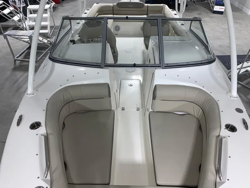 Slide: The Image of 2024 Key West 239 DFS boat interior with beige seating and windshield. - 5