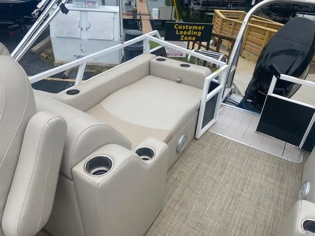 Slide: The Image of Interior of a 2017 JC 245 TT Spirit boat with beige seating and cup holders. - 12