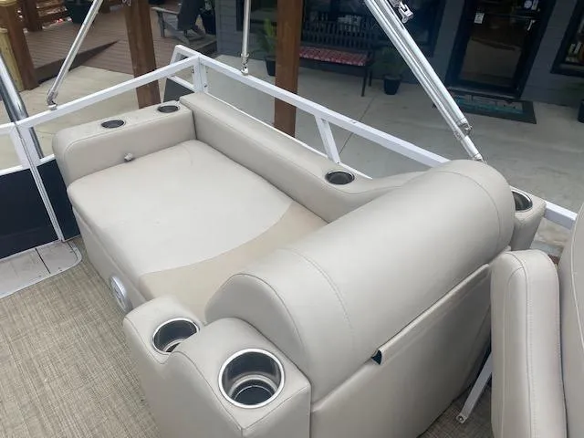 Slide: The Image of Luxury seating on 2017 JC 245 TT Spirit pontoon boat with cup holders. - 13