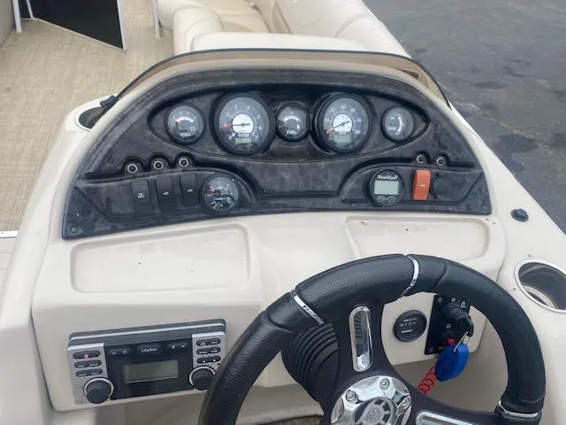 Slide: The Image of Control panel and steering wheel of a 2017 JC 245 TT Spirit boat. - 20