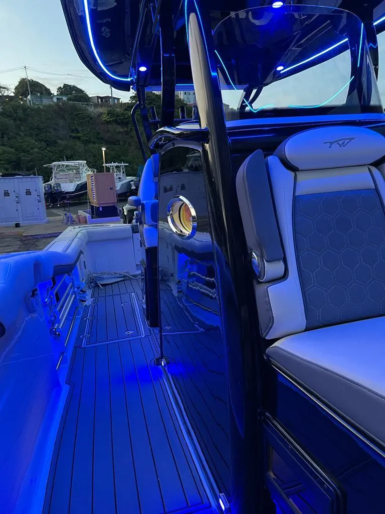 Slide: The Image of 2020 Tidewater 32 boat with blue LED lighting and luxurious seating. - 10