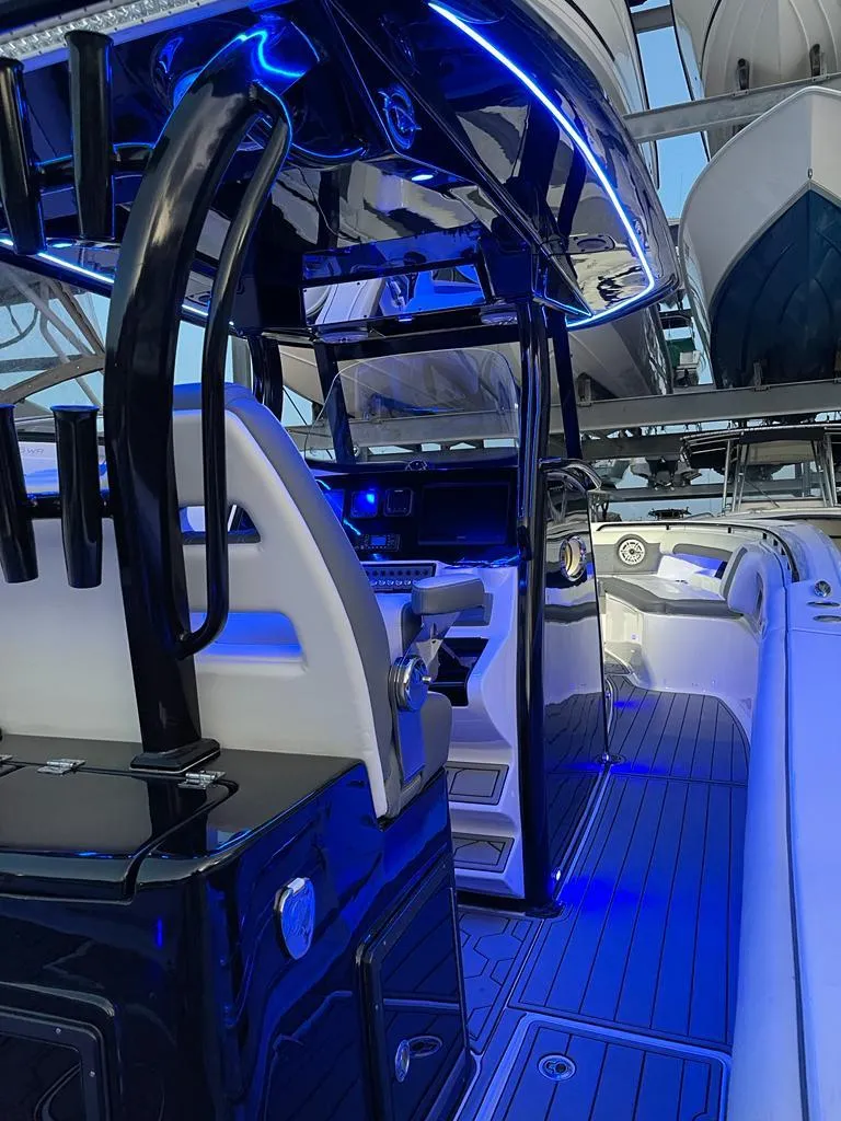 Slide: The Image of 2020 Tidewater 32 boat interior with blue LED lighting and modern dashboard. - 11