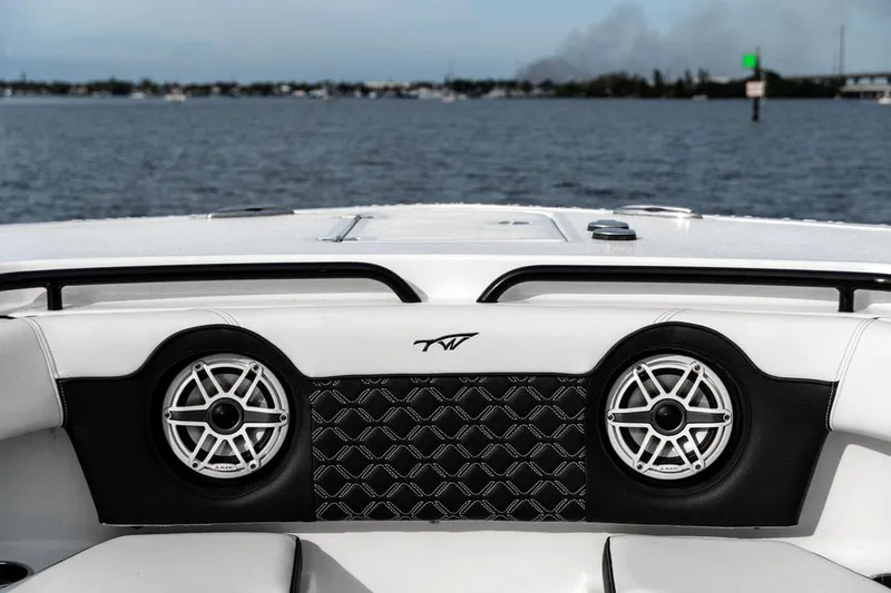 Slide: The Image of Tidewater 32 boat interior with speakers, 2020 model, on a calm water body. - 19