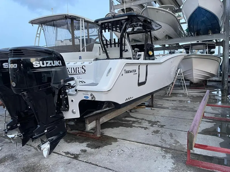 Slide: The Image of 2020 Tidewater 32 boat with twin Suzuki engines in a marina. - 2