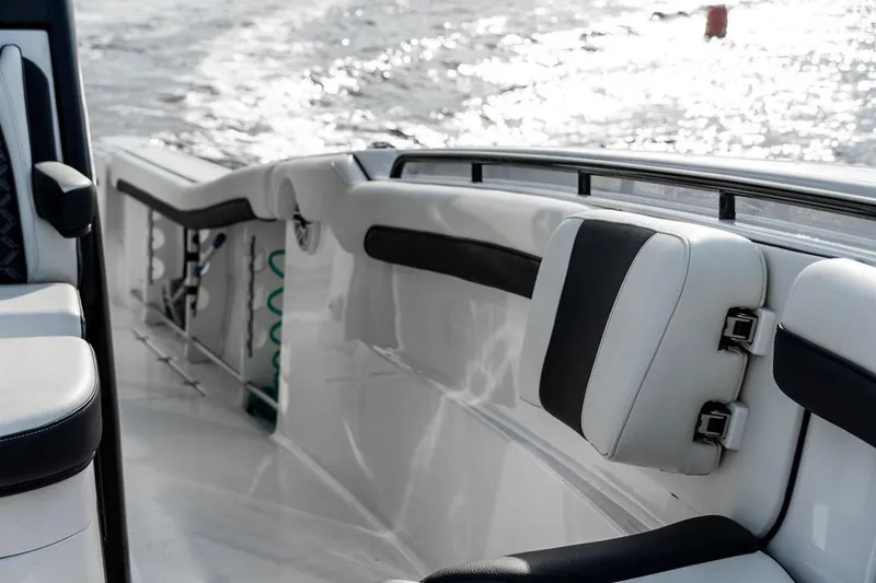 Slide: The Image of 2020 Tidewater 32 boat interior with cushioned seating and ocean view. - 21
