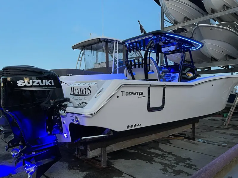 Slide: The Image of 2020 Tidewater 32 boat with Suzuki outboard motor and blue LED lights. - 3