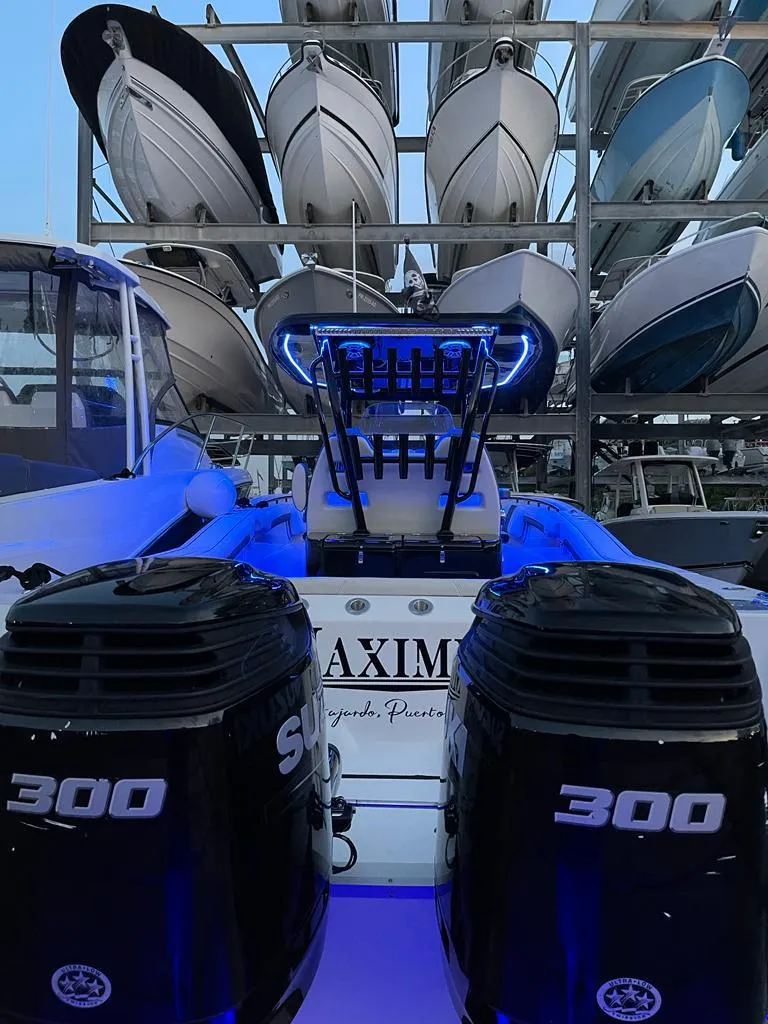 Slide: The Image of Tidewater 32 boat with dual 300 HP engines in a marina, 2020 model. - 7