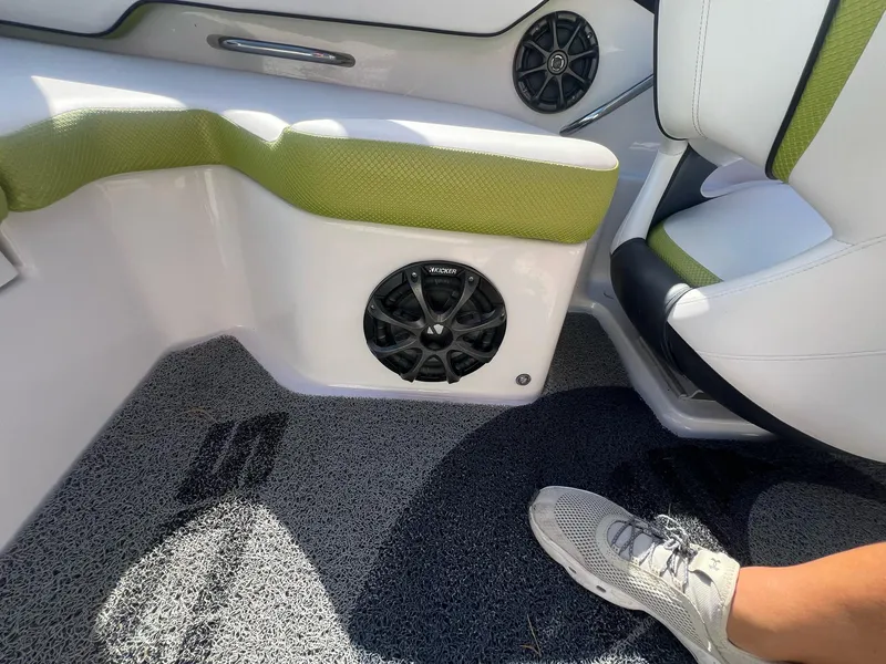 Slide: The Image of Interior of 2014 Scarab 195 HO Impulse boat with green accents and speaker system. - 10