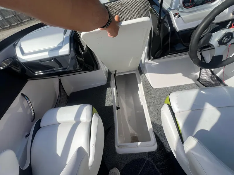 Slide: The Image of 2014 Scarab 195 HO Impulse boat interior with open storage compartment. - 12