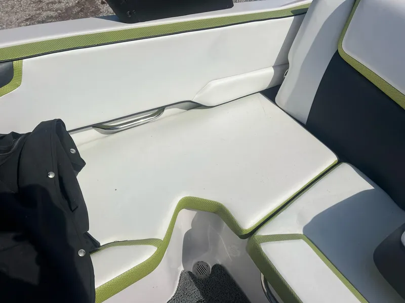 Slide: The Image of Interior seating of 2014 Scarab 195 HO Impulse boat with white and green upholstery. - 14