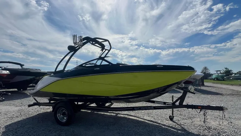 Slide: The Image of 2014 Scarab 195 HO Impulse boat on trailer under cloudy sky. - 19